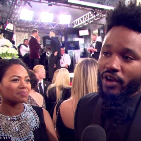 Ryan Coogler is talking to the interviewer as Zinzi Coogler looks on.